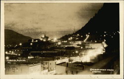 View of Town at Night with Lights Postcard