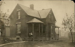 House with Two Children Sitting on Front Porch House with Two Children Sitting on Front Porch