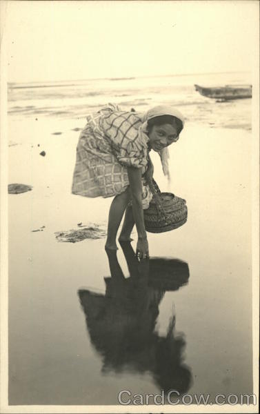 Woman Working on the Beach with a Basket Philippines