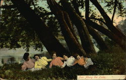 Six ladies reclining in the grass under some trees Postcard