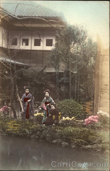 Japanese ladies in kimonos standing in a garden
