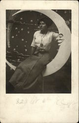 Woman Sitting on a Paper Moon Postcard