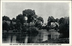 The Outpost Inn from Highway looking across Lake Postcard
