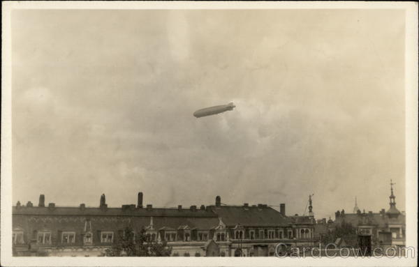 Blimp Flying High Above Buildings Airships