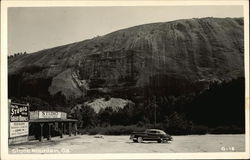 Sudio Shop in front of Large Rock Formation Postcard