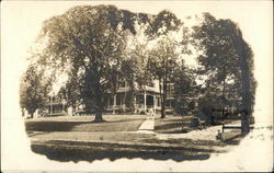 Photo on Woman in Front of Large House Postcard