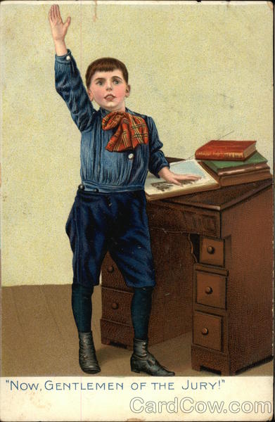 Little Boy Standing at a Desk and Raising His Hand