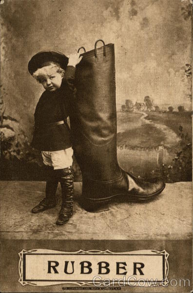 Child Standing Next to Same Sized Rubber Boot Children