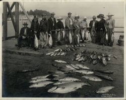 Group of People with Fish on Dock Group of People with Fish on Dock
