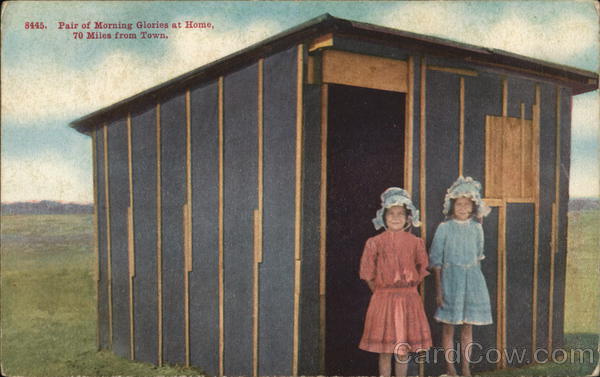Two Girls in Front of a Barn