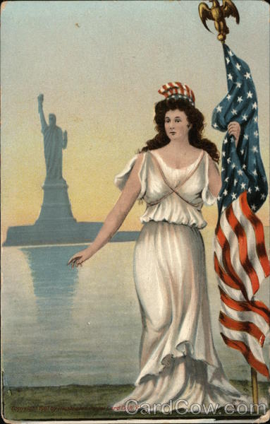 Women in White Dress Holding American Flag in fromt of the Statue of Liberty