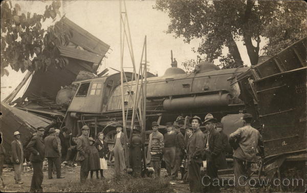 People standing next to a train that has been wrecked