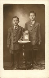Two Boys Standing By Table With Book Two Boys Standing By Table With Book