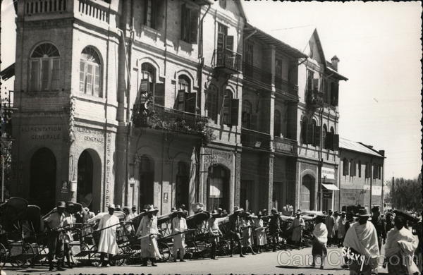 Rickshaw drivers Que up in front of store fronts in Madagascar