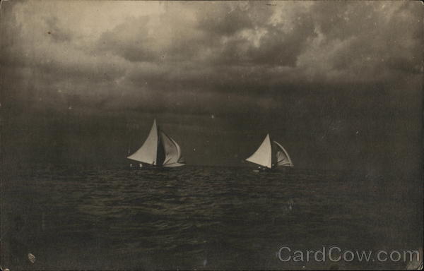 Two Sailboats in the Water With a Dark, Cloudy Sly