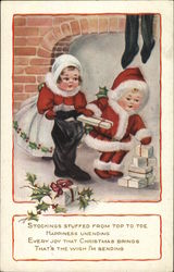 children filling stockings with gifts Postcard Postcard Postcard