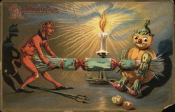 Halloween - devil and scarecrow pulling a popper in front of a candle Halloween - devil and scarecrow pulling a popper in front of a candle