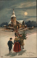 A Merry Christmas to You - Family in front of a church carrying a tree Postcard Postcard Postcard