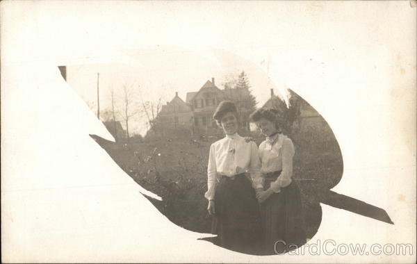 Snapshot of Two Women In Front of Residences Leaf Vignette