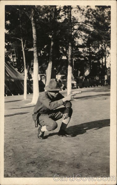 A Crouched Soldier Aiming His Pistol People in Uniform