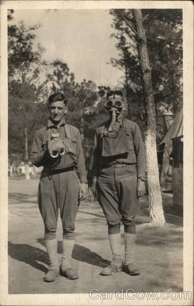 Soldiers in Camp, One with a Gas Mask People in Uniform