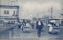 Rolling chairs on boardwalk, near Steeple Chase Pier Atlantic City, NJ Postcard Postcard Postcard