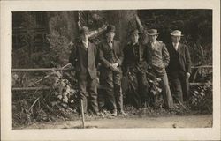 Five Men by Fence, Tree Trunk and Building in Background Postcard