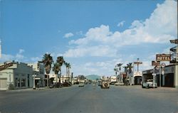 View looking east on main business street Postcard