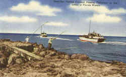 Deep Sea Fishing Cruisers Passing Fishermen On The Jetties Scenic, FL Postcard Postcard