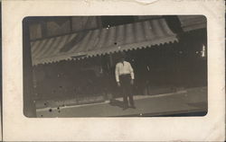 A man in front of a store A man in front of a store