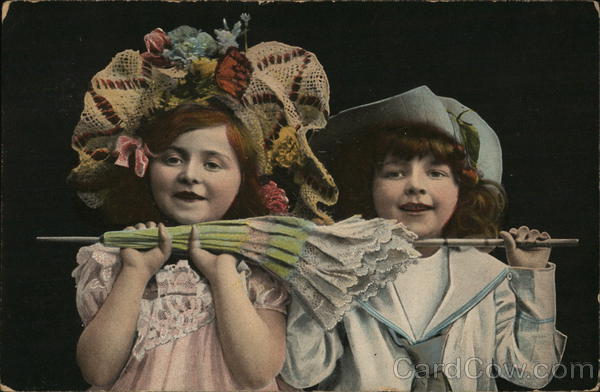Two Young Girls Holding a Closed Umbrella