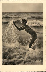 A Woman in a Bikini Plays in the Ocean Postcard
