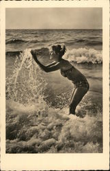 A Woman in a Bikini Plays in the Ocean A Woman in a Bikini Plays in the Ocean
