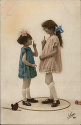 Two Young Girls Facing Each Other, Index Fingers Extended Two Young Girls Facing Each Other, Index Fingers Extended