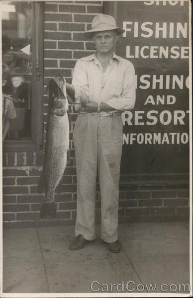 Man Holding 14-lb. Northern Pike Near Building Park Rapids Minnesota