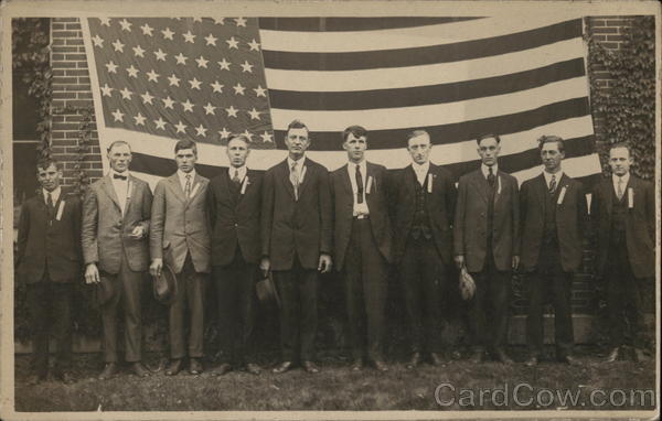 10 Men Lined Up, Standing in Front of American Flag