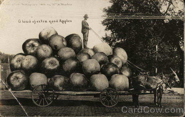 Farmer Standing on Pile of Giant Apples on a Cart Hawkeye Iowa