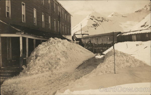 Building Near Mountains with Snow-Covered Walkway Shoveled Out