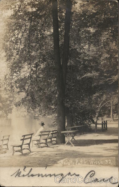 Person Seated on Bench Under Trees Near Water Philadelphia Pennsylvania