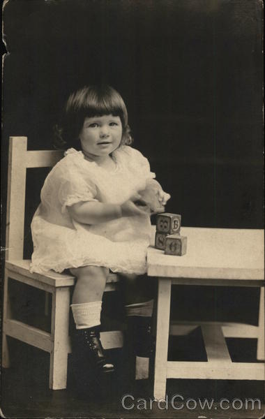 Girl Seated at Table with Blocks Girls