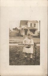 Small Child Playing with Croquet Mallet Small Child Playing with Croquet Mallet