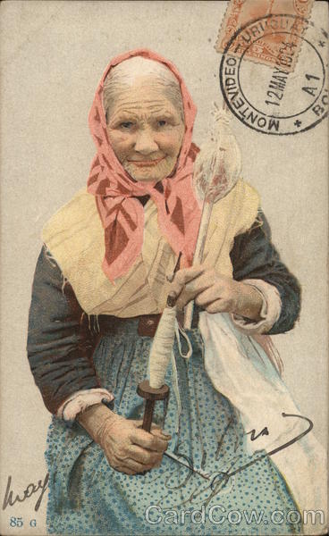 Older Woman in Pink Scarf Holding Large Spool and Tool