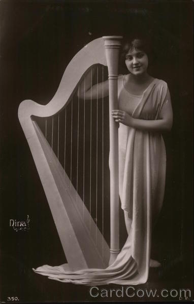 Woman in Flowing Garment Standing Next to Harpsichord