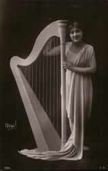 Woman in Flowing Garment Standing Next to Harpsichord Women Postcard Postcard