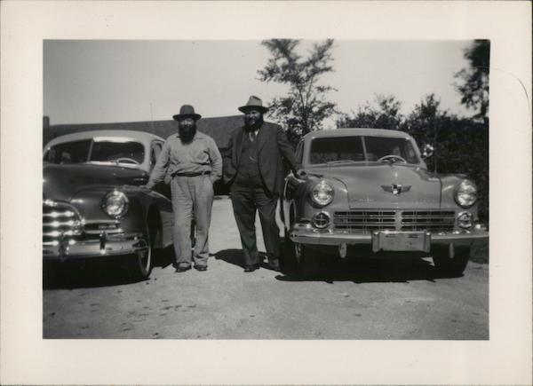Two Men Standing by Two Cars House of David