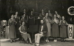 Group Photo of Ladies in Gowns on Stage, One Man Seated Postcard