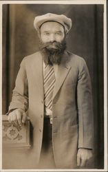 Bearded Man Wearing Hat, One Hand on Podium Postcard