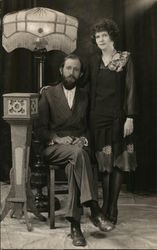 Fashionably Dressed Man and Woman Near Ornate Lamp Postcard