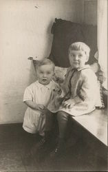 Two Young Children, One Seated, One Standing Postcard