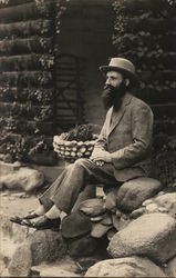 A Man Sitting on Rocks Postcard